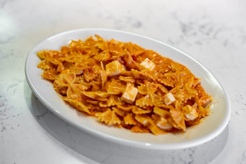 Farfalle Napolitano: bowtie pasta in a pink tomato cream sauce with cubes of fresh mozzarella