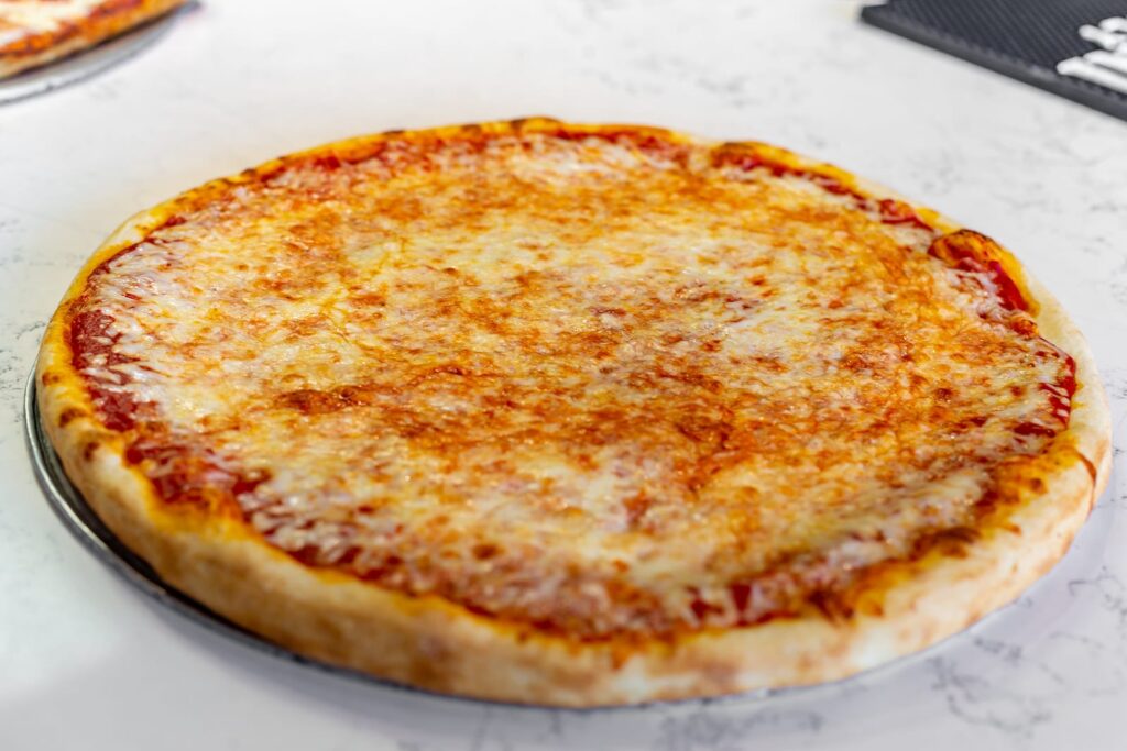 A round Neopolitan cheese pie with tomato sauce and golden mozzarella